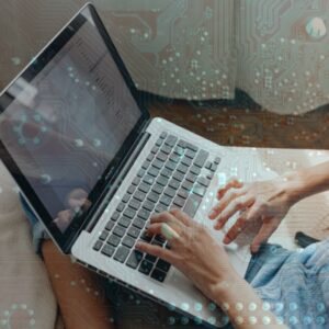 Person typing on laptop overlaid with digital circuit board pattern – representing managed IT services, remote tech support, and cybersecurity solutions from eCreek IT Solutions, a Denver-based MSP specializing in small business technology and cloud migration