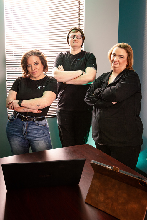 Three eCreek IT team members standing with arms crossed in an office, representing local IT support and cybersecurity professionals serving Denver, Colorado businesses